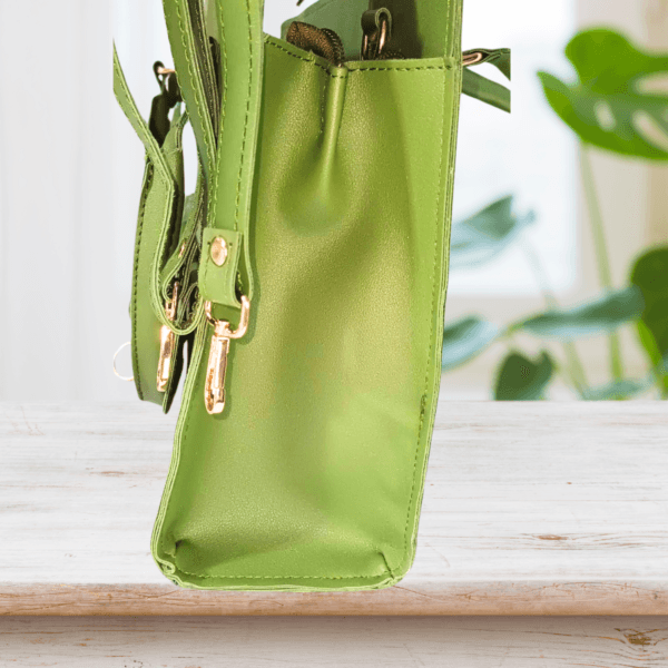 "Green handbag with dual front pockets, gold-tone hardware, and detachable shoulder strap – Stylish ladies’ purse for everyday use"
