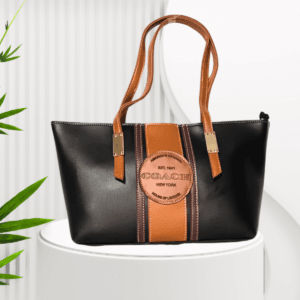 "Black and tan leather tote bag with gold-tone hardware – Stylish ladies' handbag for everyday use"